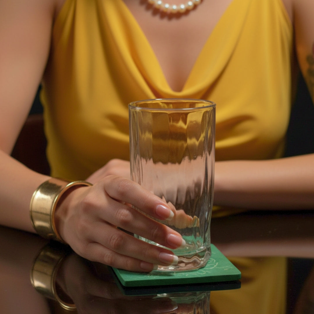 A lady holding a juice glass
