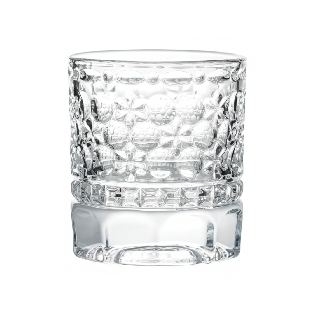Clear glass tumbler with textured design on a white background